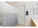 Cozy bathroom features a shower with a decorative curtain, towel rack, and convenient doorway access at 2306 E Parkside Ln, Phoenix, AZ 85024