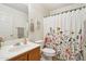 Relaxing bathroom featuring a floral shower curtain and modern sink and toilet fixtures at 2306 E Parkside Ln, Phoenix, AZ 85024