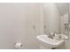 Powder room featuring a pedestal sink, neutral paint, and toilet paper holder at 2306 E Parkside Ln, Phoenix, AZ 85024