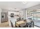 Bright kitchen with stainless steel appliances, white cabinets, and dining area with pool views at 2306 E Parkside Ln, Phoenix, AZ 85024