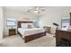 Spacious main bedroom featuring a ceiling fan, large window, and comfortable furnishings at 2306 E Parkside Ln, Phoenix, AZ 85024