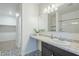 Bright bathroom features stylish black and white patterned tile flooring and a large mirror at 2625 W Gaby Rd, Phoenix, AZ 85041