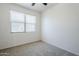 Sun-filled bedroom featuring neutral carpeting and window at 2625 W Gaby Rd, Phoenix, AZ 85041