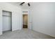 Carpeted bedroom features closet with doors and another doorway at 2625 W Gaby Rd, Phoenix, AZ 85041