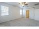 Light and airy bedroom with fan, plush carpet, dual windows, and ensuite entrance at 2625 W Gaby Rd, Phoenix, AZ 85041