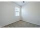 Clean bedroom features neutral carpet, a ceiling fan and bright light at 2625 W Gaby Rd, Phoenix, AZ 85041