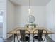 Dining room features a rustic wood table, industrial chairs, stylish lighting, and flooring at 2625 W Gaby Rd, Phoenix, AZ 85041
