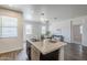 Bright open floor plan kitchen featuring an island with counter seating flowing into the living room at 2625 W Gaby Rd, Phoenix, AZ 85041