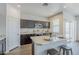 Kitchen island with stainless steel appliances, breakfast bar, dark cabinets and white countertops at 2625 W Gaby Rd, Phoenix, AZ 85041