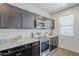 Modern kitchen with stainless steel appliances, ample cabinet space, and light countertops at 2625 W Gaby Rd, Phoenix, AZ 85041