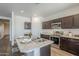 Modern kitchen with an island, stainless steel appliances, and warm wood cabinetry at 2625 W Gaby Rd, Phoenix, AZ 85041