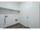 Clean laundry room with essential hookups, convenient shelf, and neutral tones for a functional space at 2625 W Gaby Rd, Phoenix, AZ 85041