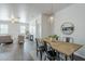 Open floor plan of dining room and living room with neutral tones and sleek wood flooring at 2625 W Gaby Rd, Phoenix, AZ 85041