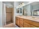 This bathroom has a light wood vanity, tiled floor, and a walk-in shower at 2662 S Springwood Blvd # 462, Mesa, AZ 85209