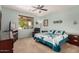 This bedroom offers carpet, a ceiling fan, and window letting in natural light at 2662 S Springwood Blvd # 462, Mesa, AZ 85209