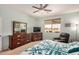 This bedroom features carpet, a ceiling fan, and a relaxing chair in front of a window at 2662 S Springwood Blvd # 462, Mesa, AZ 85209