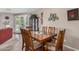 Warm dining room featuring a wooden table with seating for six and a view to the outside at 2662 S Springwood Blvd # 462, Mesa, AZ 85209