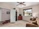 The carpeted living room has a ceiling fan, sofa, TV, and outside views through a window at 2662 S Springwood Blvd # 462, Mesa, AZ 85209