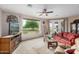 Bright living room featuring a large picture window with views of the outdoors, a ceiling fan, and comfortable seating at 2662 S Springwood Blvd # 462, Mesa, AZ 85209