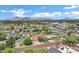 Wide aerial view of neighborhood displaying lush trees, houses, and mountain landscape at 3046 E Glenrosa Ave, Phoenix, AZ 85016