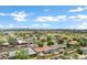 Residential neighborhood showcasing well-maintained homes, mature trees, and city views under a partly cloudy sky at 3046 E Glenrosa Ave, Phoenix, AZ 85016