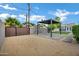 Serene backyard featuring a modern pergola, gravel landscaping, and a secure fence at 3046 E Glenrosa Ave, Phoenix, AZ 85016