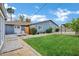 Expansive backyard with a pergola, a lawn, and thoughtful landscaping creates a great outdoor living space at 3046 E Glenrosa Ave, Phoenix, AZ 85016