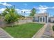 Charming backyard featuring a lush lawn, stepping stone path, and cozy guest house at 3046 E Glenrosa Ave, Phoenix, AZ 85016