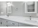 Bathroom featuring double vanity with quartz countertops, modern fixtures, framed mirrors, and decorative lighting at 3046 E Glenrosa Ave, Phoenix, AZ 85016