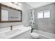 Bathroom featuring a vanity with white quartz countertops, modern fixtures, and a bathtub with a shower at 3046 E Glenrosa Ave, Phoenix, AZ 85016