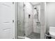 Modern bathroom featuring a glass-enclosed shower with rain shower head and gray tile at 3046 E Glenrosa Ave, Phoenix, AZ 85016
