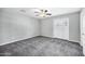 Bedroom features new carpet, ceiling fan, and access to the exterior and a second door at 3046 E Glenrosa Ave, Phoenix, AZ 85016