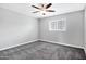 Bedroom featuring neutral walls, ceiling fan with light fixture, carpet flooring, and a window providing natural light at 3046 E Glenrosa Ave, Phoenix, AZ 85016