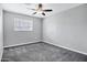 Bedroom featuring neutral walls, ceiling fan with light fixture, carpet flooring, and a window providing natural light at 3046 E Glenrosa Ave, Phoenix, AZ 85016