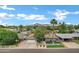 Charming single-Gathering home featuring a well-manicured lawn, mature trees, and a mountain backdrop under a bright blue sky at 3046 E Glenrosa Ave, Phoenix, AZ 85016
