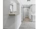 Hallway featuring white trim, gray walls, and white cabinets, as well as a closet with natural light at 3046 E Glenrosa Ave, Phoenix, AZ 85016