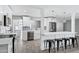 Open-concept kitchen and living space with kitchen island, bar seating and stainless steel appliances at 3046 E Glenrosa Ave, Phoenix, AZ 85016