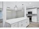 Bright, open kitchen featuring a quartz island, modern light fixture, and stainless steel appliances at 3046 E Glenrosa Ave, Phoenix, AZ 85016