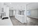 Modern kitchen island with bar seating, quartz countertop, and stainless steel appliances at 3046 E Glenrosa Ave, Phoenix, AZ 85016