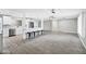 Open-concept living room, with kitchen island, bar stools and new light fixture at 3046 E Glenrosa Ave, Phoenix, AZ 85016