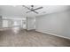 Open-concept living area with modern flooring, ceiling fan, and seamless flow to kitchen and entryway at 3046 E Glenrosa Ave, Phoenix, AZ 85016
