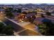 Aerial view of a residential home with desert landscaping at dusk in suburban neighborhood at 3488 N Lady Lake Ln, Casa Grande, AZ 85122