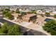 A charming home with mature trees and solar panels is featured in this scenic aerial shot at 3488 N Lady Lake Ln, Casa Grande, AZ 85122