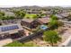 This aerial shot reveals a home with a private backyard pool and solar panels in a welcoming neighborhood at 3488 N Lady Lake Ln, Casa Grande, AZ 85122