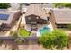 An aerial view captures the backyard's pool, putting green, and a cozy outdoor seating area at 3488 N Lady Lake Ln, Casa Grande, AZ 85122