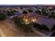 Aerial view of a residential home featuring backyard with pool and spa at dusk at 3488 N Lady Lake Ln, Casa Grande, AZ 85122