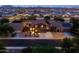 Aerial view of a residential home with desert landscaping at dusk in suburban neighborhood at 3488 N Lady Lake Ln, Casa Grande, AZ 85122