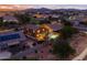 Aerial view of a residential home with desert landscaping at dusk in suburban neighborhood at 3488 N Lady Lake Ln, Casa Grande, AZ 85122