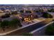 Aerial view of a residential home with desert landscaping at dusk in suburban neighborhood at 3488 N Lady Lake Ln, Casa Grande, AZ 85122