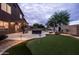 An expansive backyard with a putting green, inground pool, hot tub, and patio for outdoor enjoyment at 3488 N Lady Lake Ln, Casa Grande, AZ 85122
